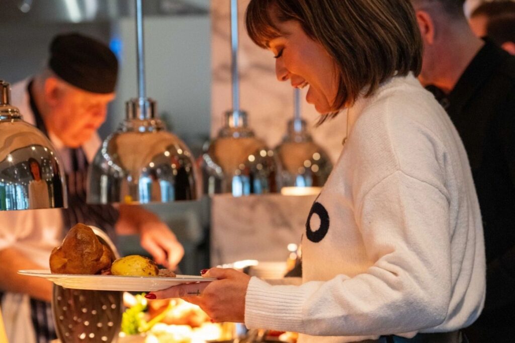 Woman serving herself from a buffet