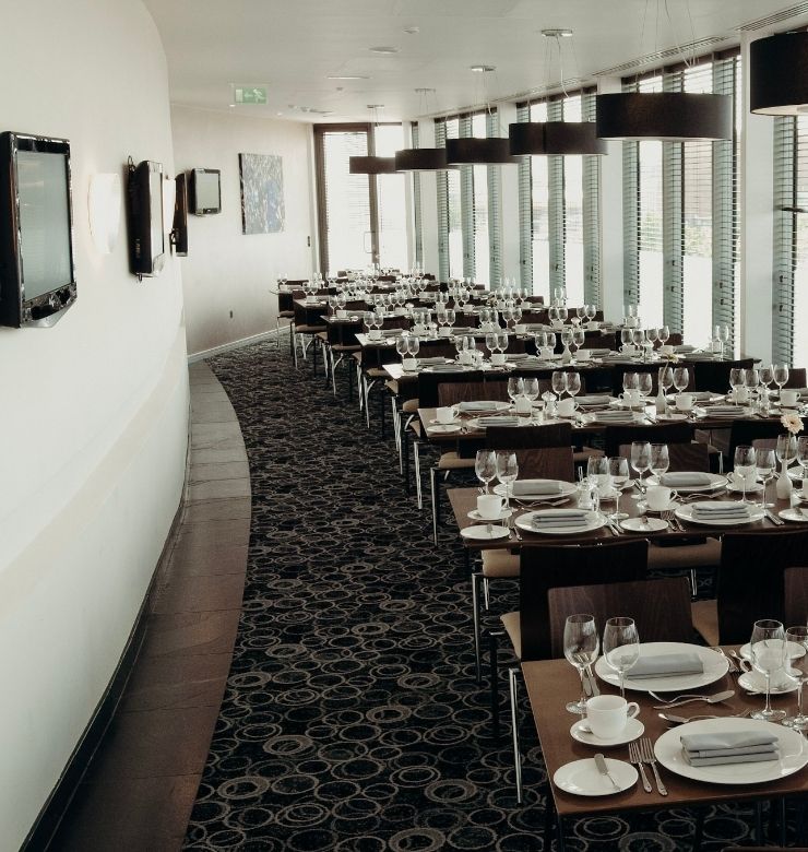 Tables lining a room with tv screens