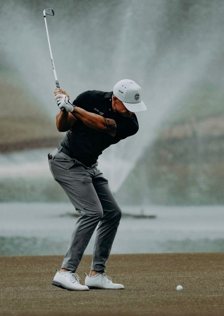 golf player hitting a ball