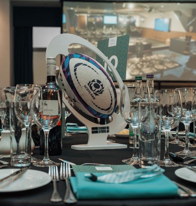 hospitality table setting with rugby ball in middle