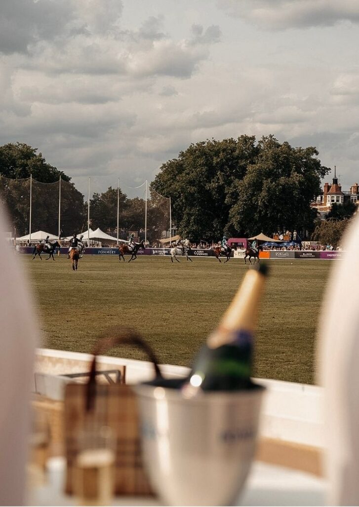 champagne bottle with polo players in the background